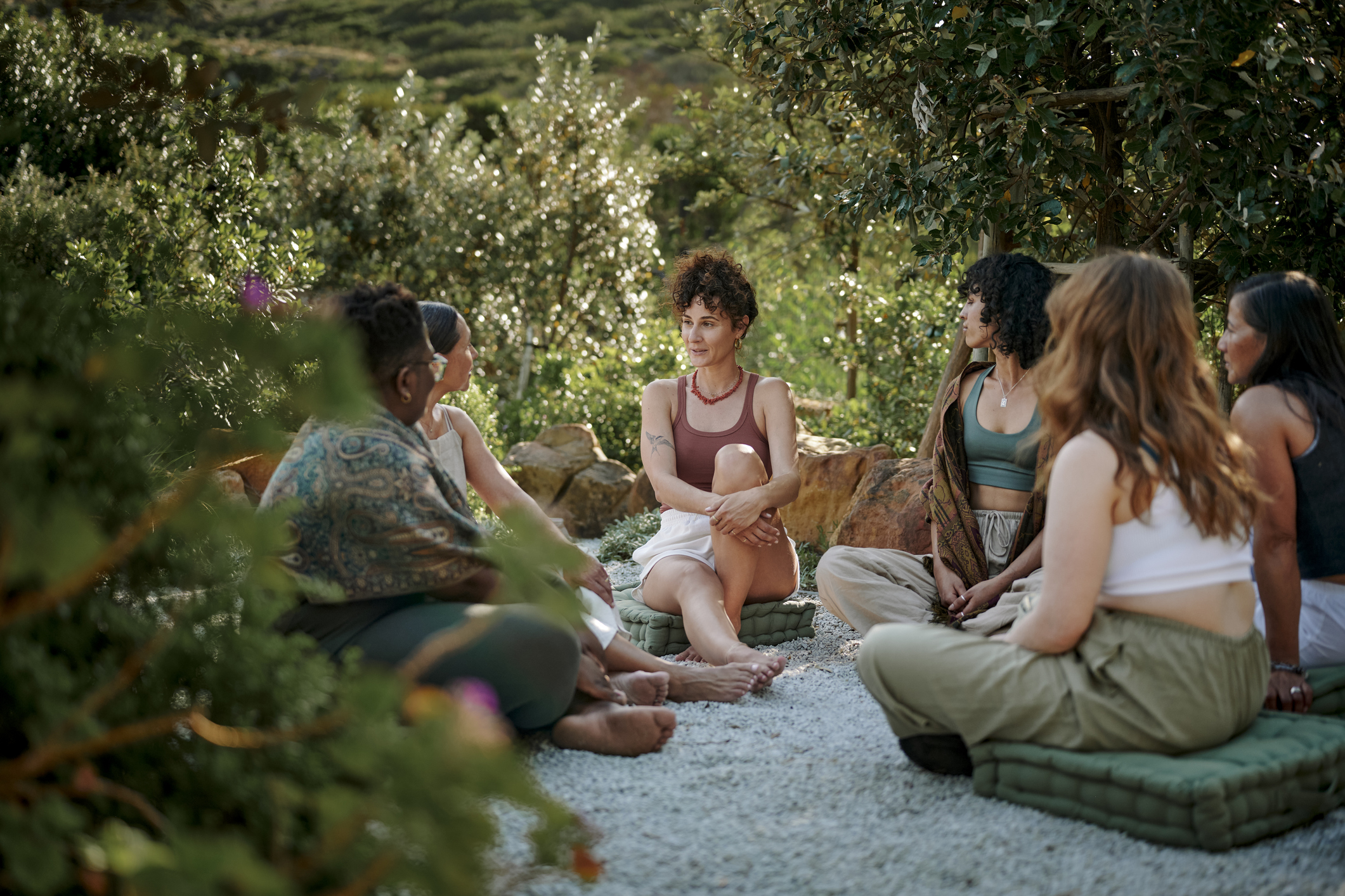 Diverse women talking in a circle outside in nature